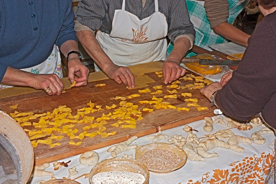 Local experiences are a crucial element of Slow Travel. Women making pasta. Editorial credit: ermess / Shutterstock.com