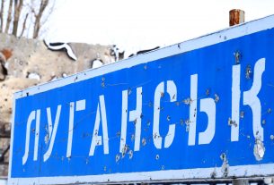 Bullet riddled sign in Donbass region. Russia invades Ukraine