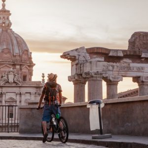 car-free Sundays in Rome. Man on bike by Colosseum
