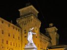 Castello Estense and statue of Savonarola at night - Our quick guide to Ferrara
