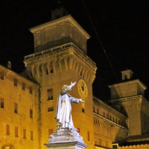 Castello Estense and statue of Savonarola at night - Our quick guide to Ferrara