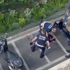 video still of police beating transsexual