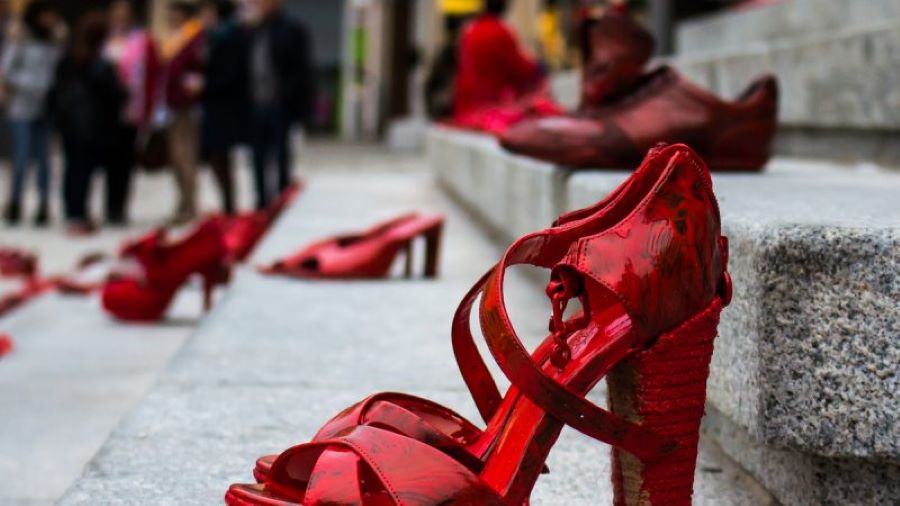 gender violence survivors to speak in schools if PM says so. Red shoes on steps