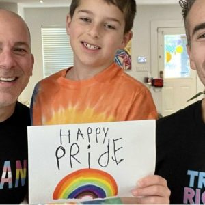 Mr Nelson and Mr Barone with their son Milo with Pride message. Credit: Instagram