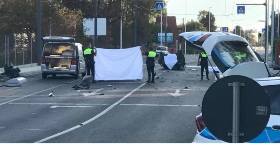 Road deaths in Sardinia - police shield the bodies of the dead at site of accident.