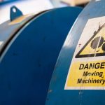 Dangerous machinery sign on blue machine.