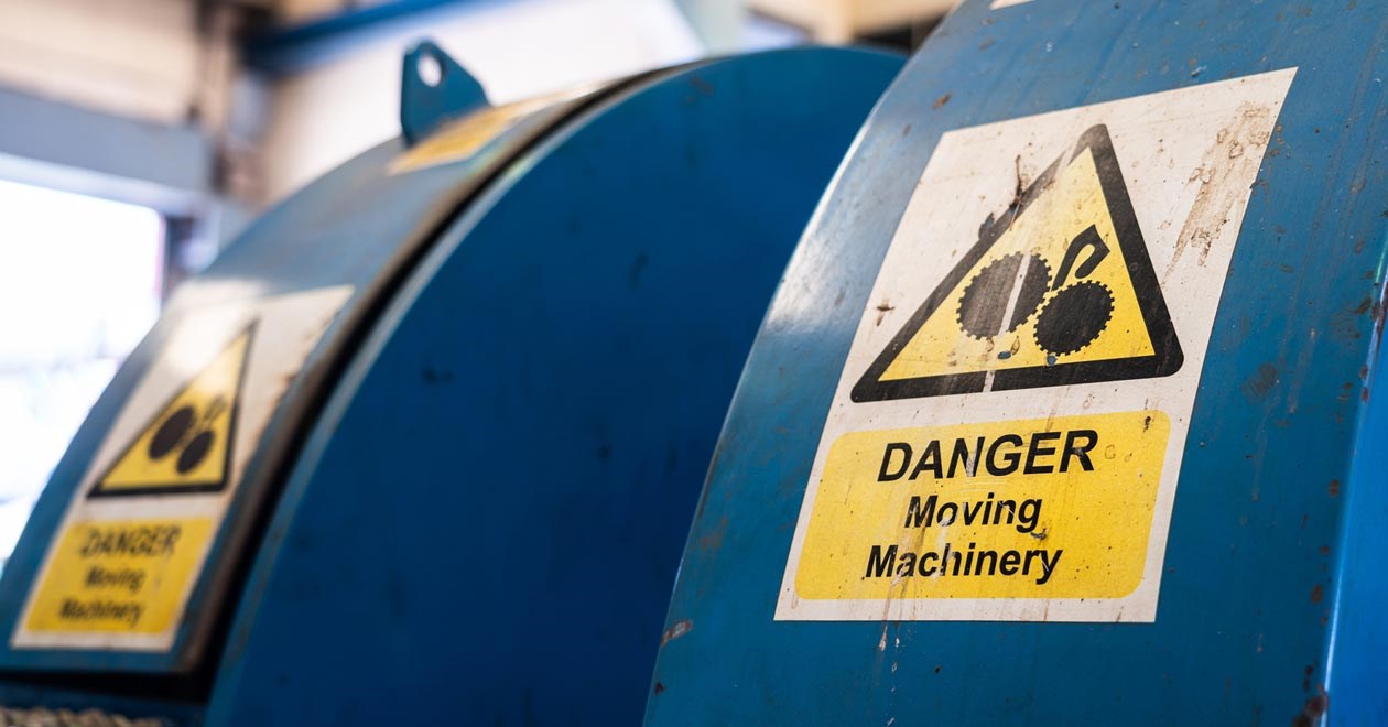 Dangerous machinery sign on blue machine.