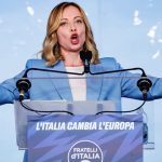 Meloni says compatible majority needed or she'll stay in opposition in Europe. Image: Meloni at lecter, arms spread, talking. Associated Press/AP