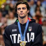 Ceccon with his 100m backstroke gold medal. Image: AFP