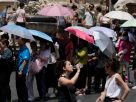Six cities on red alert for weather Tourists sheltering under umbrellas as they line up to enter the Pantheon in Rome, July 8, 2023 during the heatwave. Gregorio Borgia/AP
