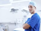 Jail time increased for attacks on medical staff. Image shows Doctor in blue outfit. Public health spending in Italy lowest in G7