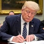 onald Trump signing an order for the Executive Team in the White House Credit: Andrew HarnikAP