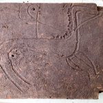 Engraved tile found covering tomb 64, thought to be anccient warrior's tomb