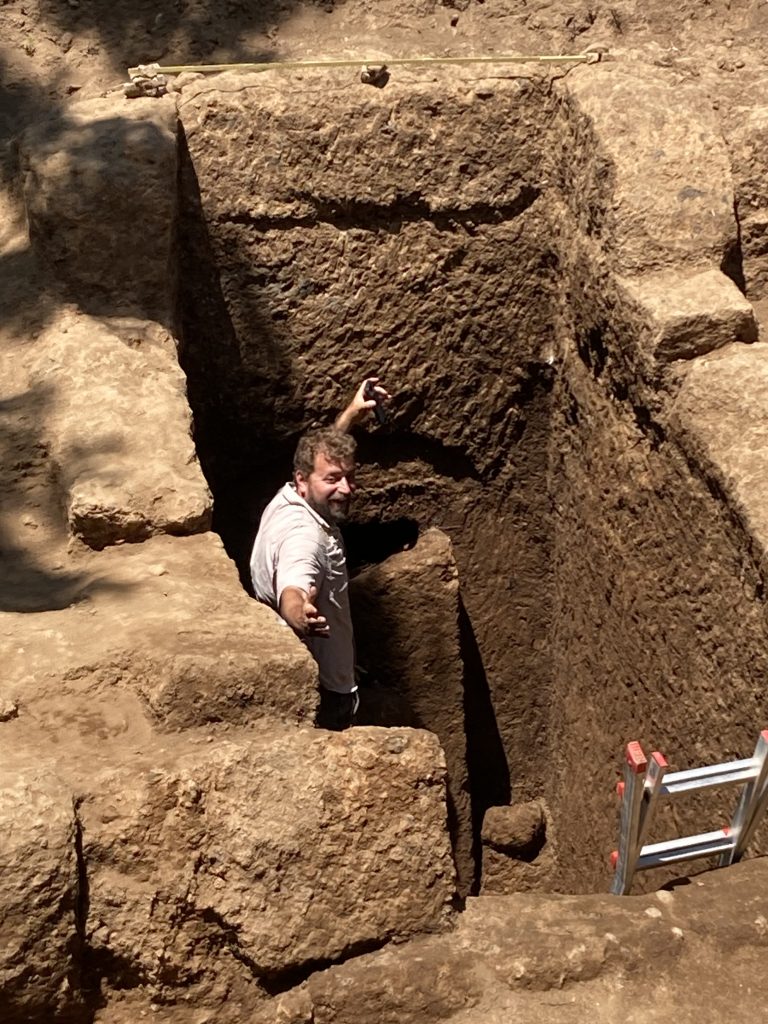 Davide Zori, Ph.D., project director and principal investigator, prepares to remove a massive stone slab that has been protecting the tomb’s entrance for more than 2600 years. (Credit: Jerolyn Morrison)