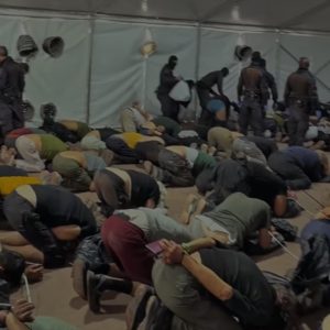 Image shows Global Sumud flotilla activists being forced to kneel whilst restrained.