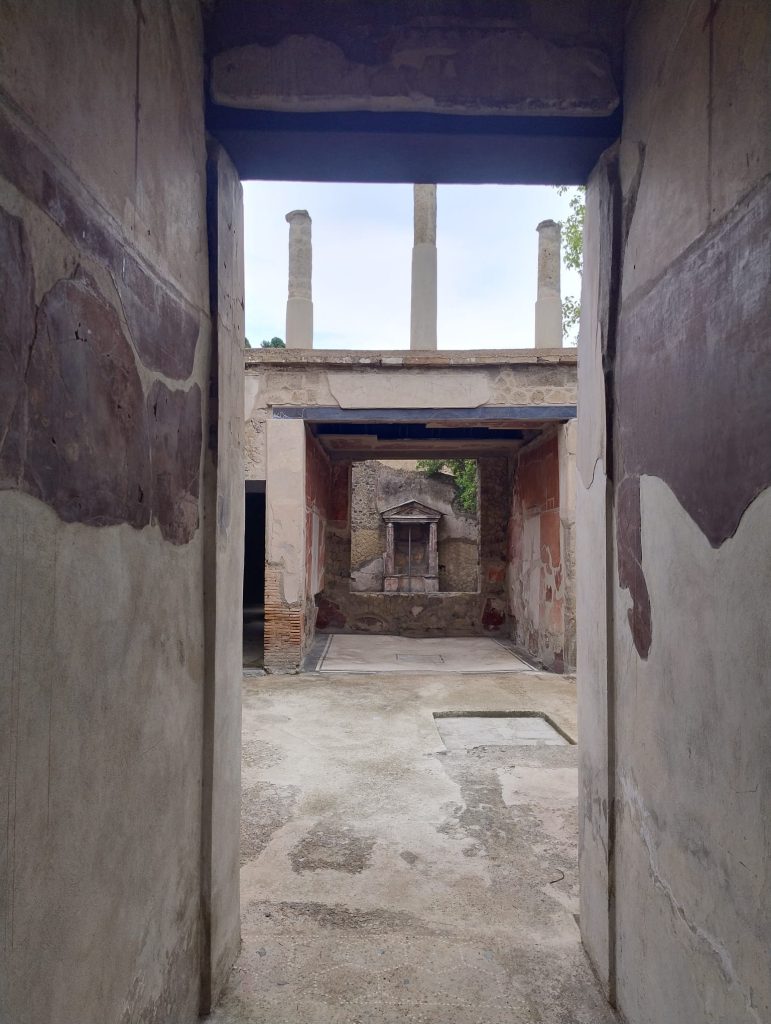 The restored House of the Carbonised Furniture showing loggia above, and shrine towards the back. Image credit: Herculaneum Archeological Park
