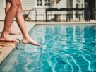 Image shows childrens feet and legs at edge of swimming pool. Pool safety in Italy is urgently being addressed