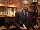 Vittorio Frescobaldi in a wine cellar holding a bottle of red wine
