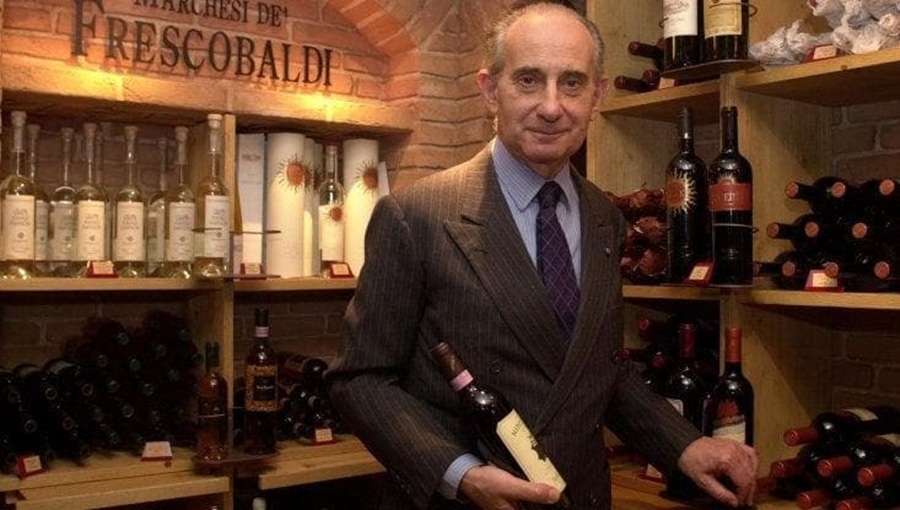Vittorio Frescobaldi in a wine cellar holding a bottle of red wine