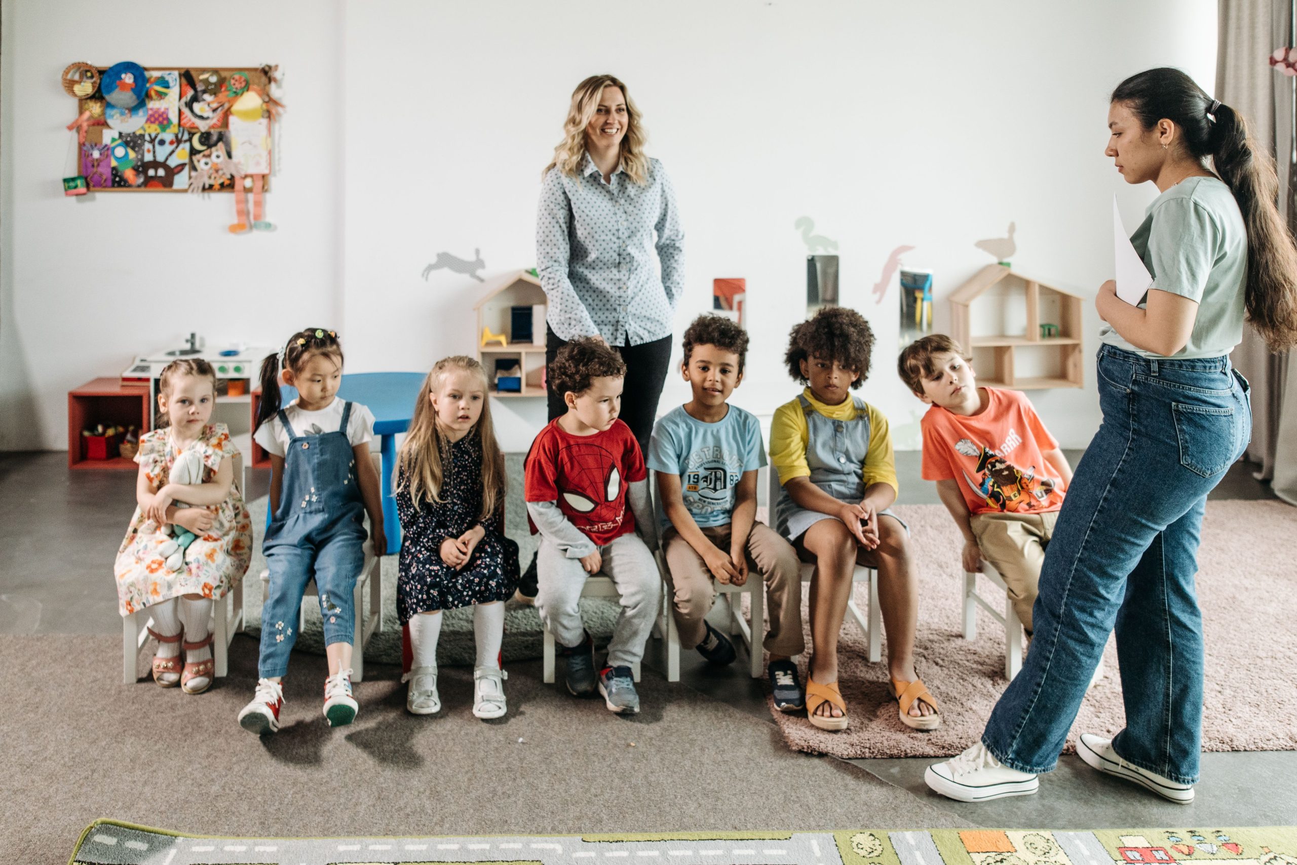 Group of children in a kindergarten classroom attending an interactive learning session with teachers. Image credit: Pavel Danilyuk https://www.pexels.com/license/